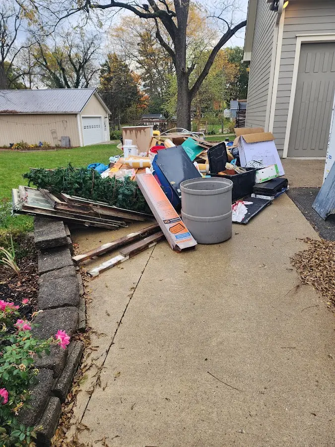 Dumpster being loaded with debris for 30 Yard Dumpster Rental in Wixom